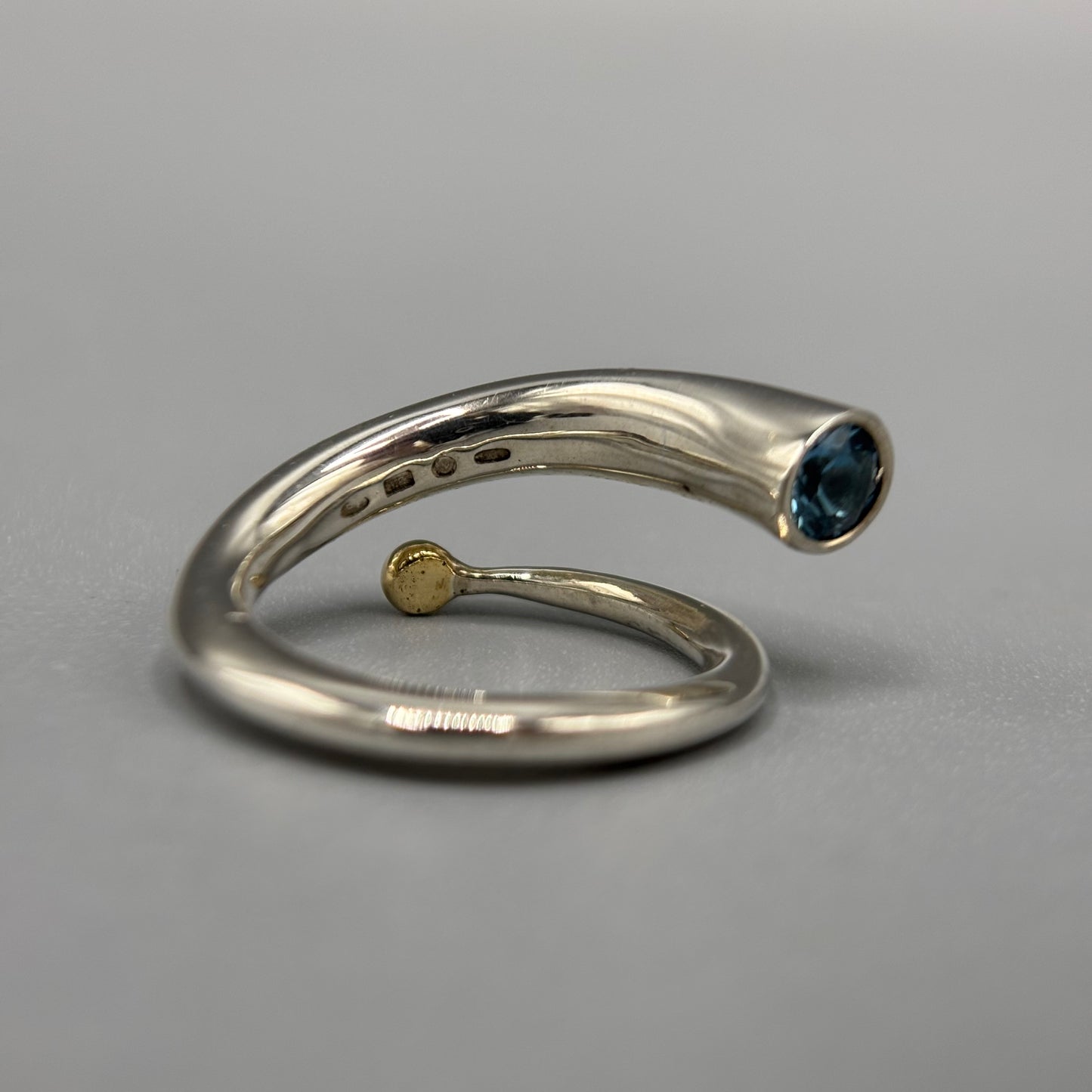 Paul Finch - Ring: Silver spiral with blue topaz & solid 18ct Yellow Gold bead