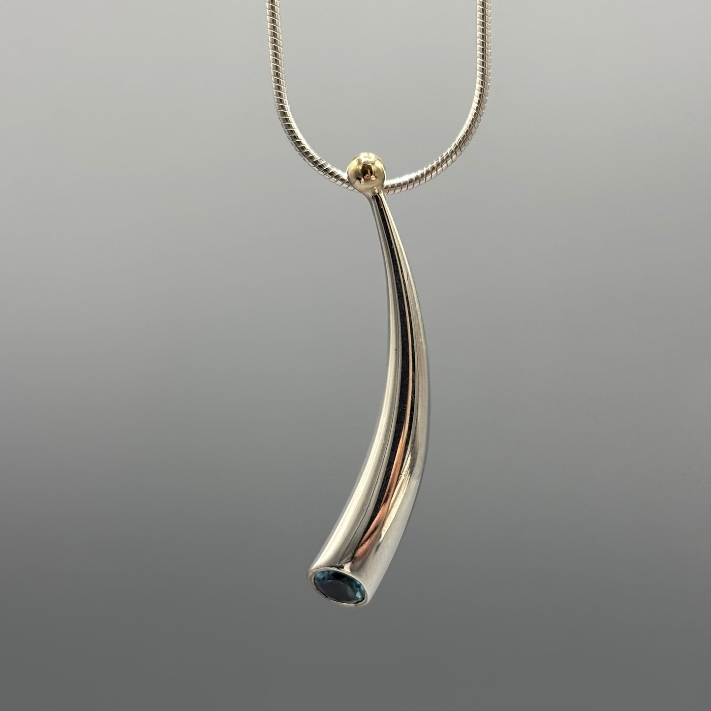 Paul Finch - Pendant: Short curved solid silver/blue topaz/solid 18ct Yellow Gold Bead